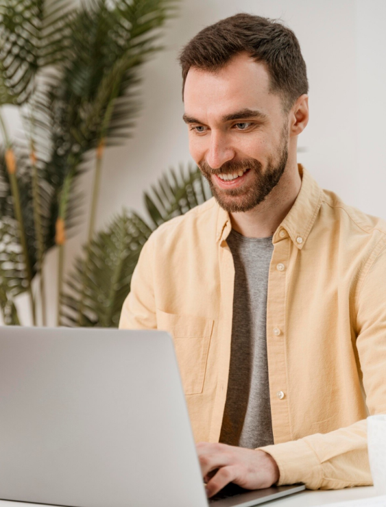 Homem feliz utilizando um notebook